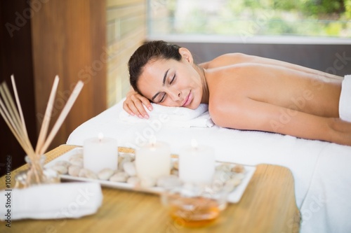 Woman lying on massage table at spa