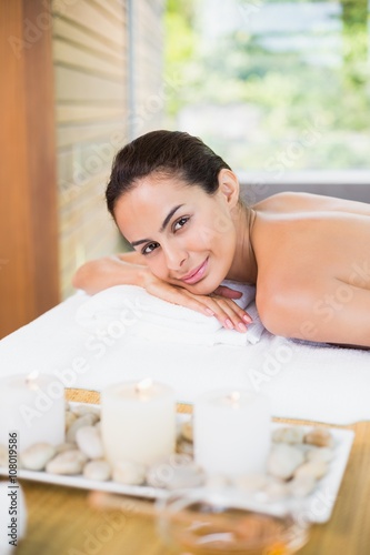 Young woman relaxing on massage table at health spa
