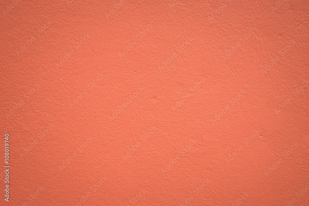 Fototapeta premium Orange color paint on concrete wall:Close up,select focus with shallow depth of field:Macro shot.