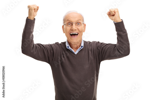 Excited pensioner gesturing happiness