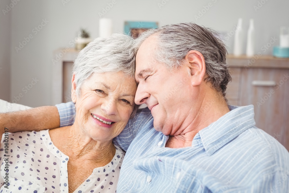 Close-up of romantic senior couple sitting on sofa Close-up of romantic senior couple sitting on sofa