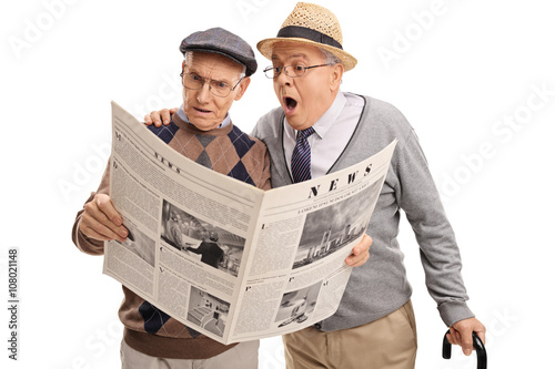 Two baffled senior men reading the news