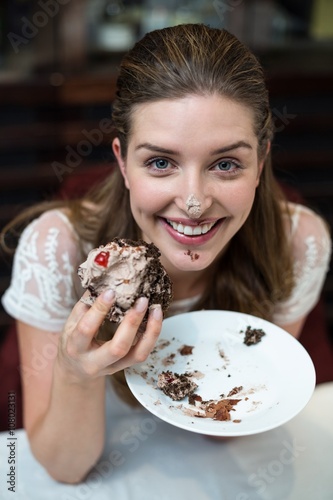 High angle portrait of happy woman enjoying cake