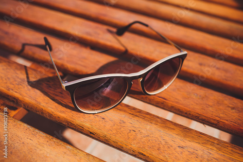 sunglasses lie on sun lounger wood