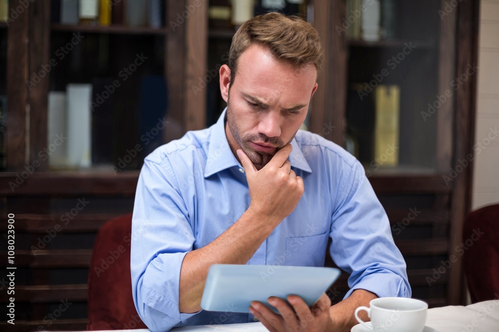 Serious businessman using digital tablet Serious businessman using digital tablet