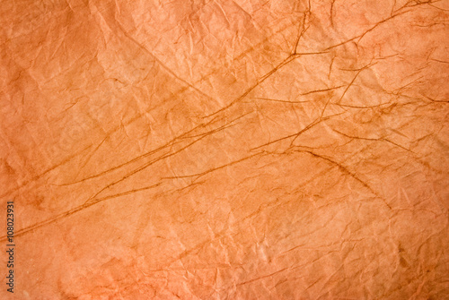 Image of crumpled orange paper closeup