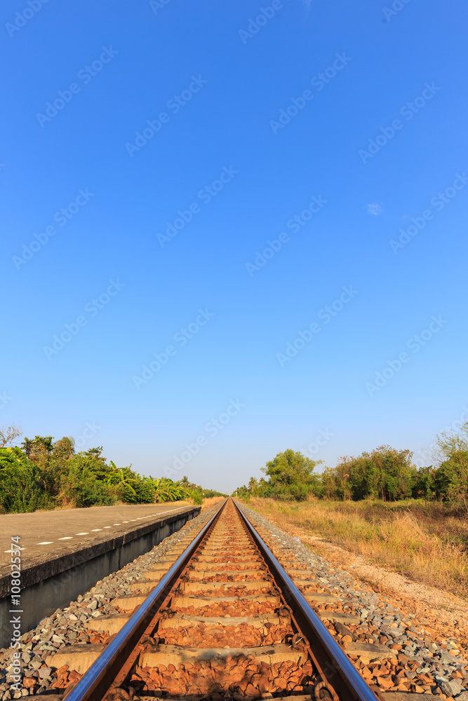 Fototapeta premium Railway tracks with blue sky in the evening