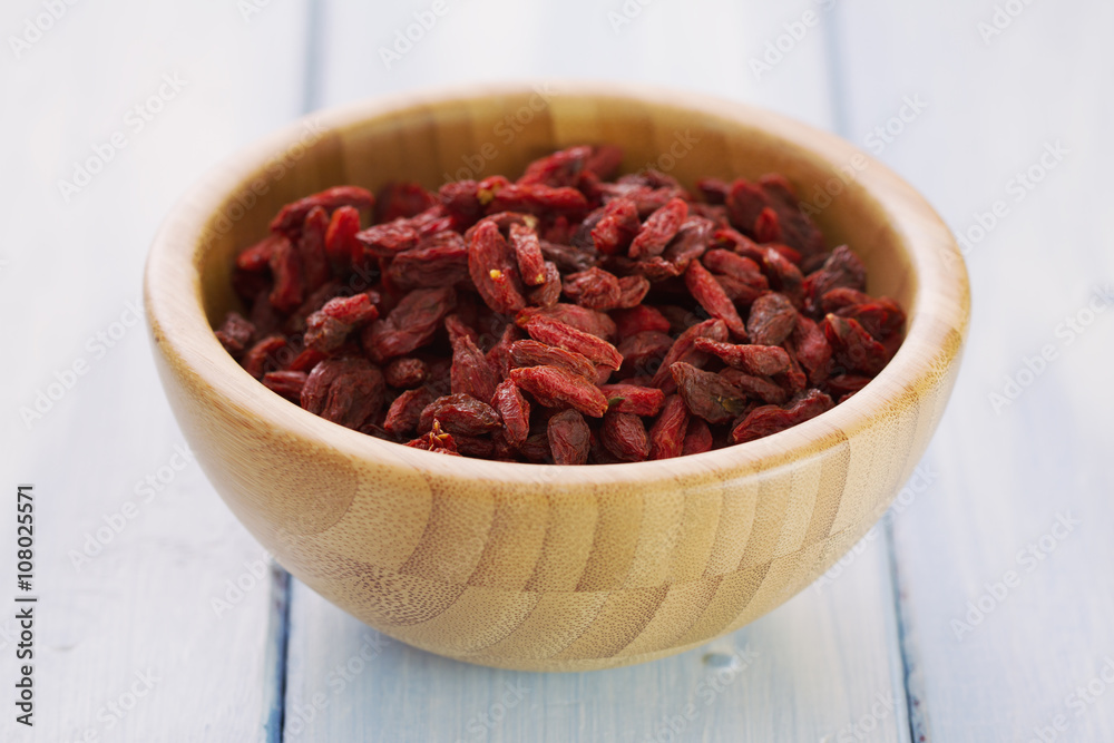 berries goji in bowl on wooden background berries goji in bowl on wooden background