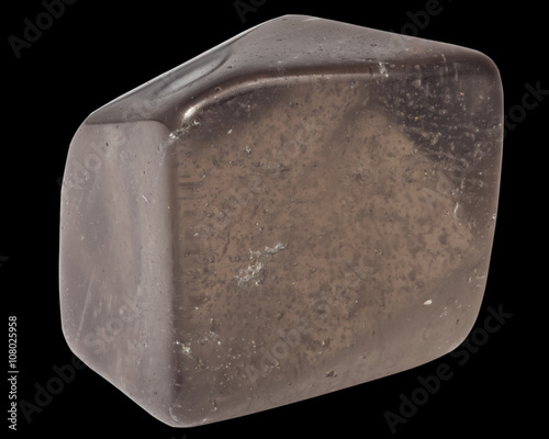 pebble of smoky quartz macro, isolated on black background