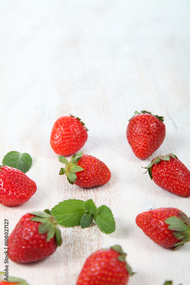 Ripe strawberry on a wooden table Ripe strawberry on a wooden table