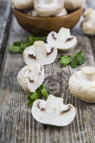 Raw mushrooms on a wooden table