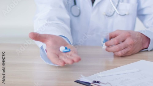Professional doctor giving pills