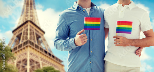 close up of male gay couple with rainbow flags © Syda Productions