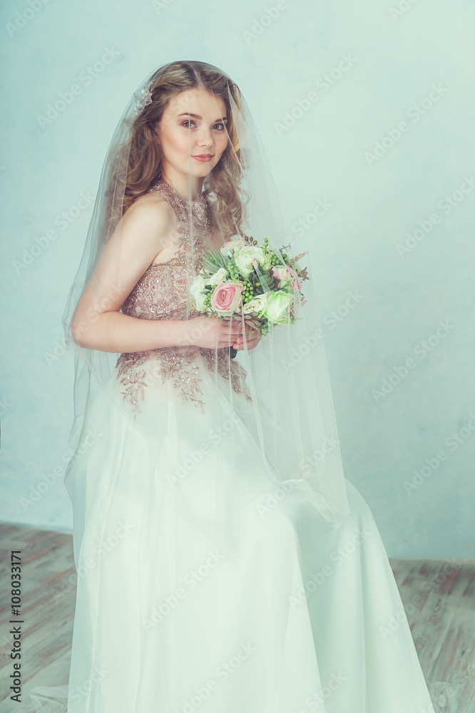 Beautiful bride in wedding dress. Portrait of young bride. Studio shot.
Beautiful bride in wedding dress. Portrait of young bride. Studio shot.