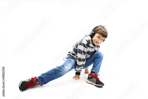  Young man with ear-phones dancing hip-hop. Isolated on white background 