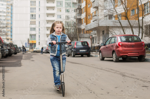 Girl on a kick scooter. © Oleg Shelomentsev