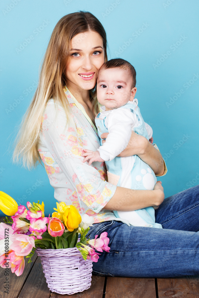 Mother and little son in studio with flowers Mother and little son in studio with flowers