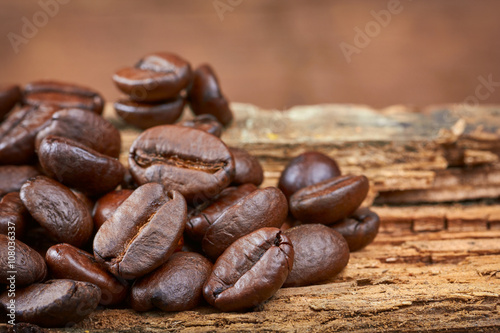 Coffee beans on wood background. Close-up