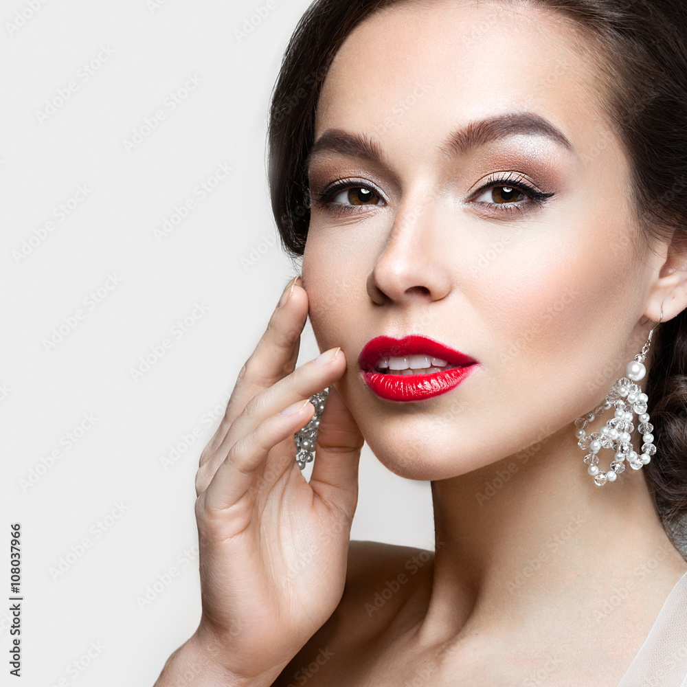 Beautiful brunette girl with perfect skin, evening make-up, wedding hairstyle and accessories.Beauty face. Beautiful brunette girl with perfect skin, evening make-up, wedding hairstyle and accessories.Beauty face.