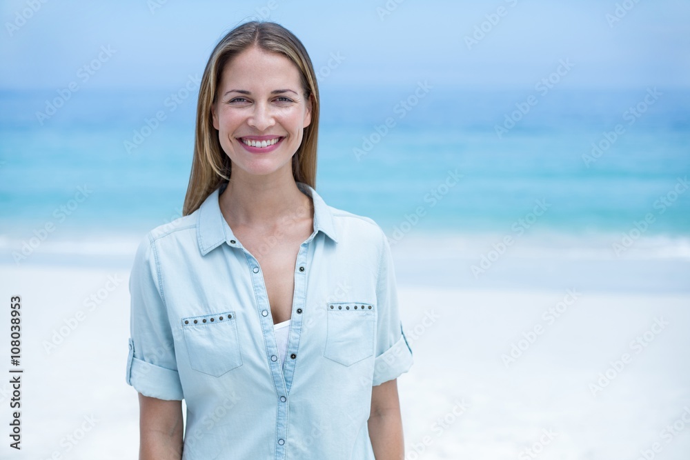 Happy beautiful woman standing at sea shore Happy beautiful woman standing at sea shore