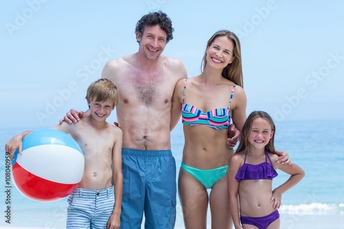 Canvas Print Cheerful family in swimwear standing at sea shore