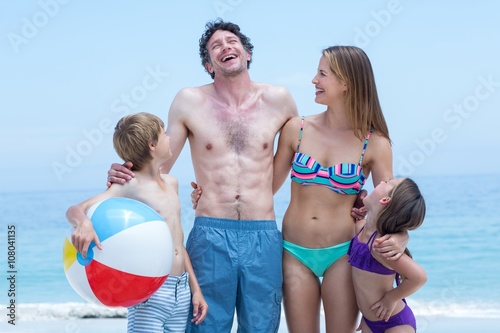 Family in swimwear standing at sea shore © WavebreakMediaMicro