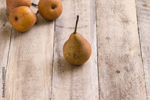 brown pears on wood table closeup
