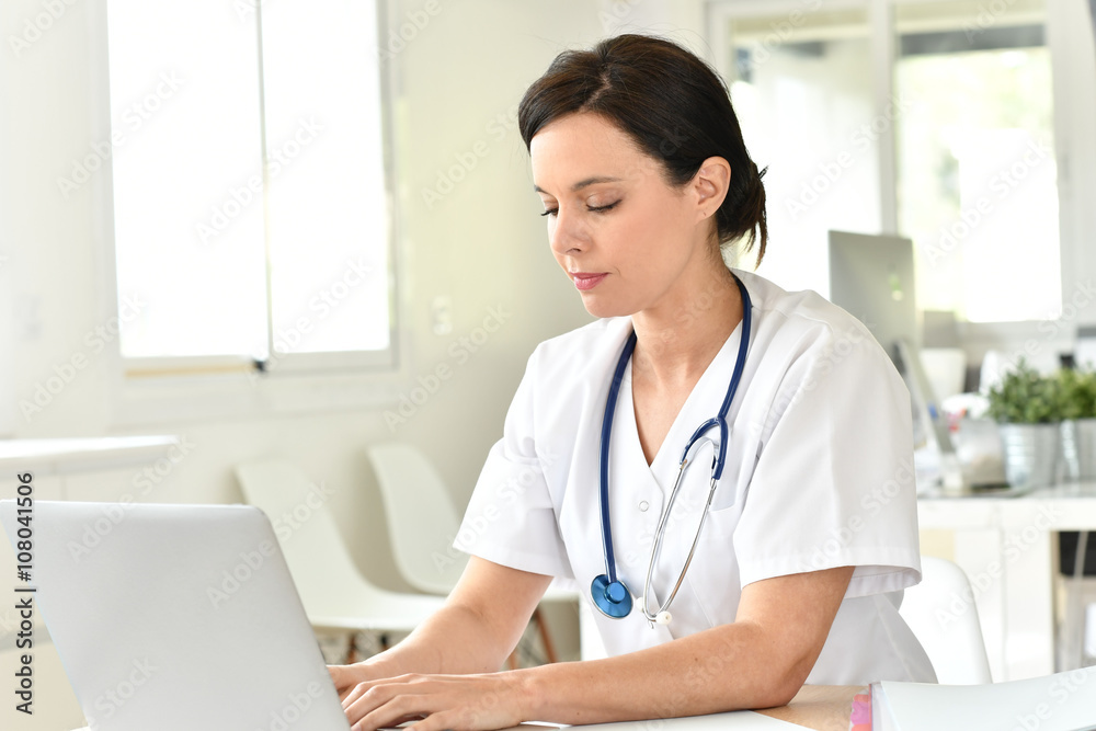 Doctor working on laptop computer Doctor working on laptop computer