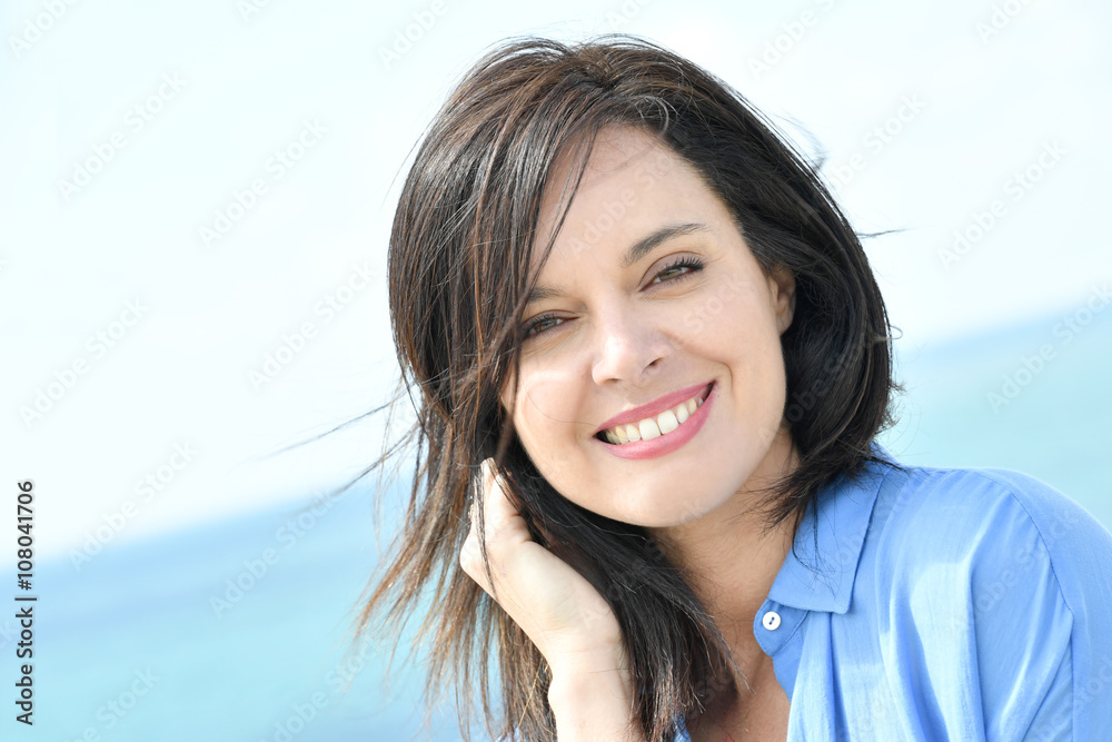 Portrait of attractive woman in blue shirt