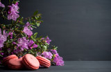 Pink macaroons on the black wooden background