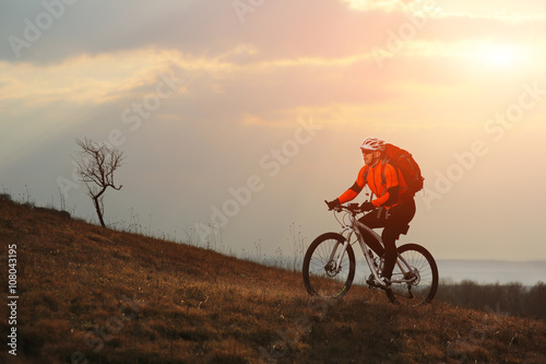 Man cyclist with backpack riding the bicycle