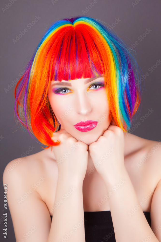Fototapeta premium beautiful woman wearing colorful wig and showing colorful nails