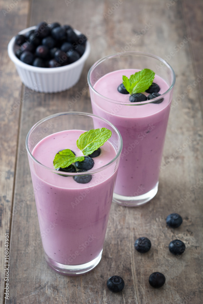 Blueberry smoothie in a glass on a rustic table
Blueberry smoothie in a glass on a rustic table