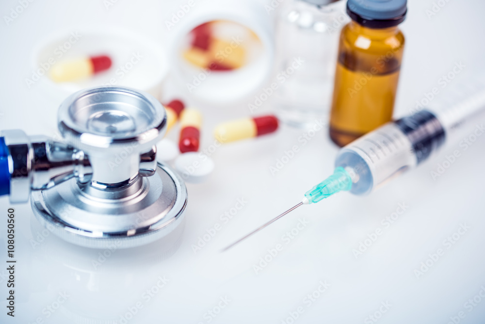 medical concept with hypodermic syringe and stethoscope