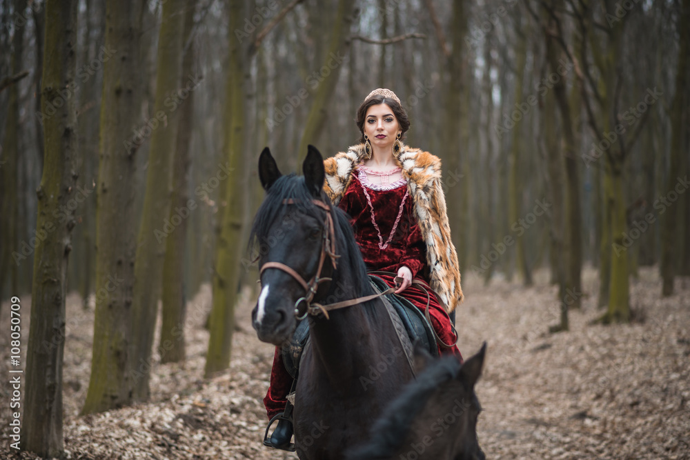 Obraz premium Princess with her horse in the woods