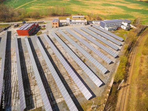 Aerial view to solar power plant in agricultural landscape. Industrial background on renewable resources theme. photo