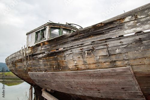 old wooden fishing boat beached on homer spit