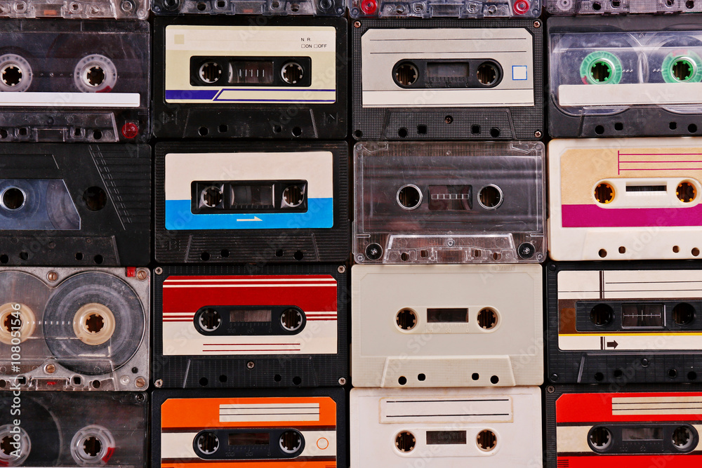 Fototapeta premium Set of old audio cassettes on wooden background