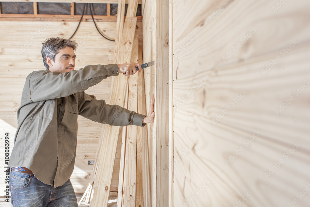 Carpenter working with house trim Carpenter working with house trim