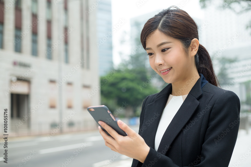 Businesswoman sending sms text message at outdoor Businesswoman sending sms text message at outdoor