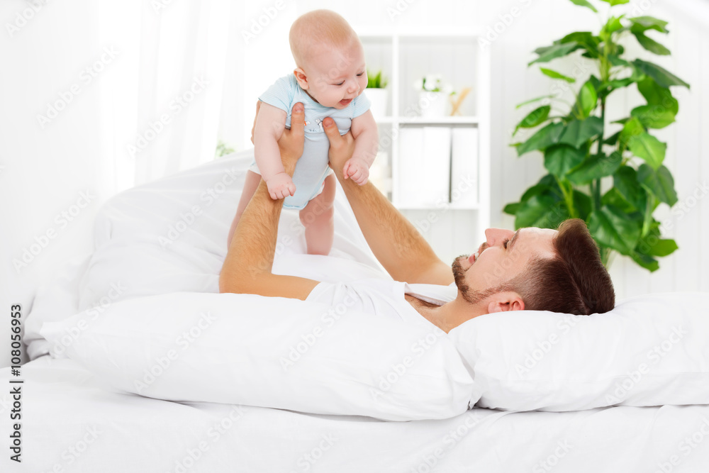 happy family father and baby on bed happy family father and baby on bed