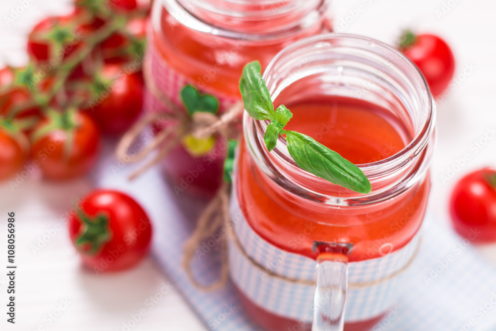 Tomato Juice and Fresh Tomatoes on a White Wooden Background