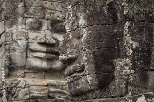 Two stone carved faces in Bayon temple  Angkor Thom  Cambodia