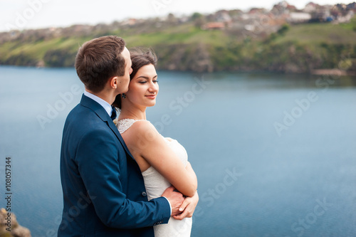 Bride and groom walking at the river © ruslan_shramko