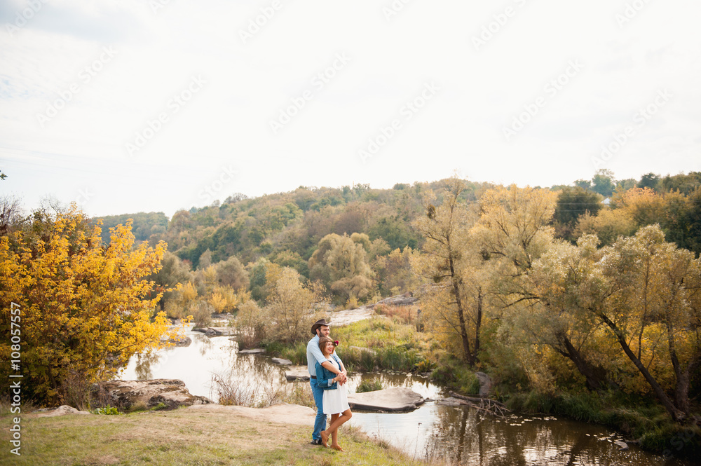 couple hugging each other near a mountain river couple hugging each other near a mountain river