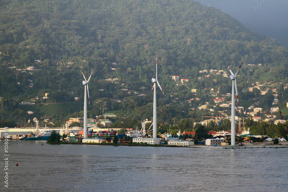 Wind generators on coast of tropical island. Victoria, Mahe, Seychelles