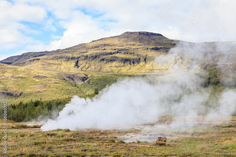 Geysir Geothermal Field.  Steam rises from a sulphur pool at the Geysir Geothermal Field and located in Haukadalur in Iceland.  The tourist attraction is part of the Golden Circle tourist trail.