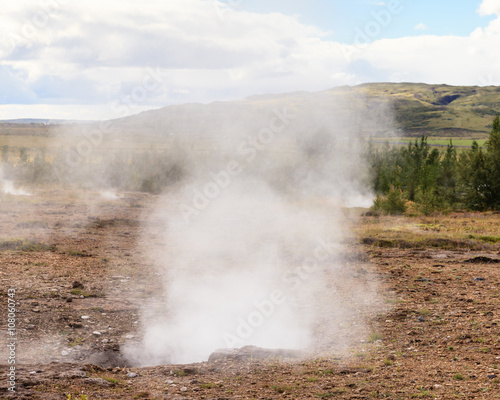 Geysir Geothermal Field. Steam rises from a sulphur pool at the Geysir Geothermal Field and located in Haukadalur in Iceland. The tourist attraction is part of the Golden Circle tourist trail.