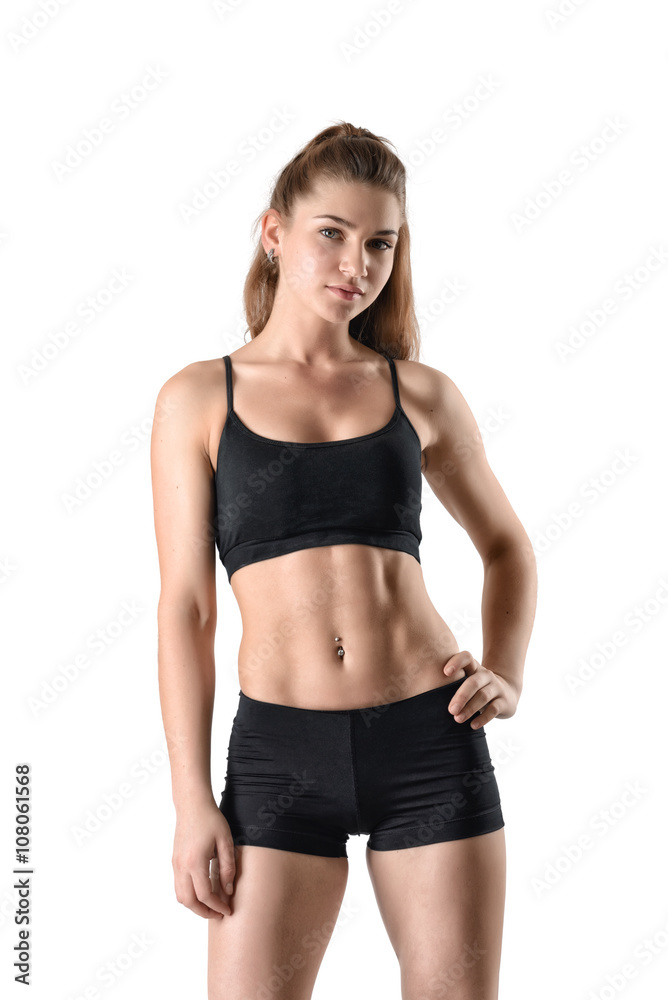 Front view of cutout young athletic woman holding her hands on waist and looking directly at the camera Front view of cutout young athletic woman holding her hands on waist and looking directly at the camera
