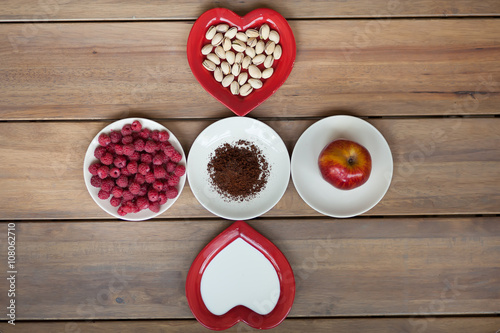 Beautiful plates with raspberry, apples, nuts, coffee grains. top view.